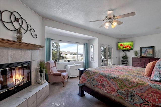 18032 Ohna Rd, Apple Valley, CA 92307 - bedroom with access to exterior, multiple windows, carpet floors, and a tile fireplace