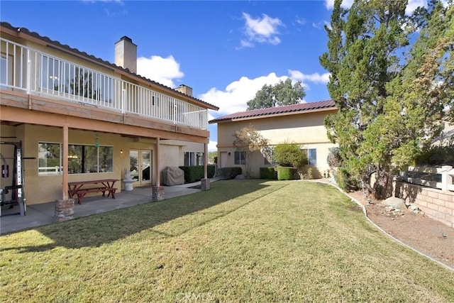 18032 Ohna Rd, Apple Valley, CA 92307 - rear view of house featuring a chimney, a yard, stucco siding, a patio area, and french doors