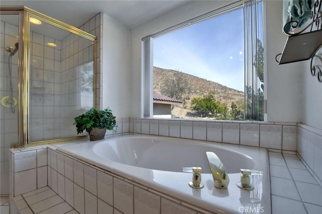 18032 Ohna Rd, Apple Valley, CA 92307 - full bathroom featuring a garden tub, tile patterned flooring, a tile shower, and a mountain view
