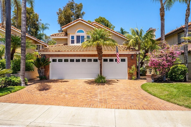 17 Springbrook Rd, Laguna Niguel, CA 92677 - mediterranean / spanish home with decorative driveway, a tiled roof, brick siding, and stucco siding