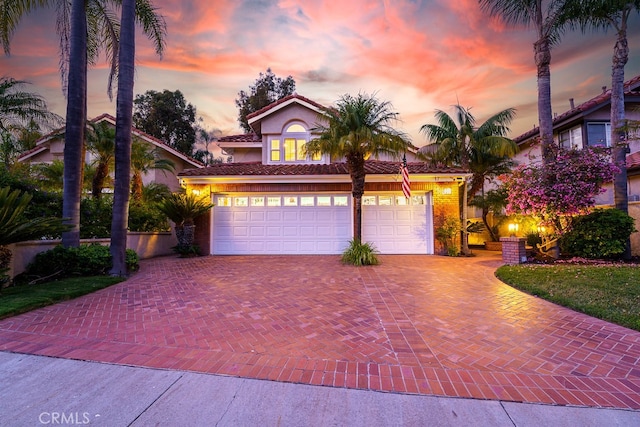 17 Springbrook Rd, Laguna Niguel, CA 92677 - mediterranean / spanish-style home featuring decorative driveway, a tiled roof, stucco siding, and a garage