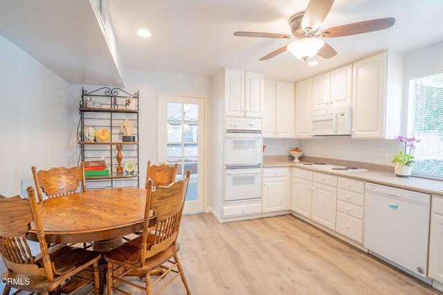 1584 Prima Ct, Camarillo, CA 93010 - kitchen with white appliances, ceiling fan, light countertops, light wood-style floors, and white cabinetry