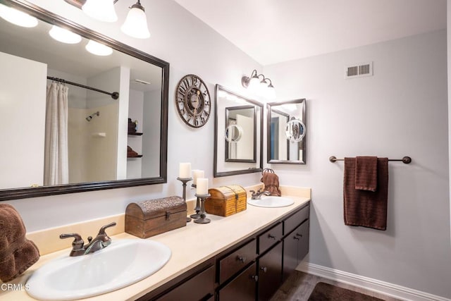 1584 Prima Ct, Camarillo, CA 93010 - full bath with double vanity, wood finished floors, and a shower with curtain
