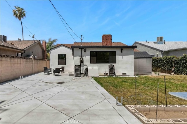 6832 Cantaloupe Ave, Van Nuys, CA 91405 - rear view of house featuring a patio area, stucco siding, a chimney, and a shed