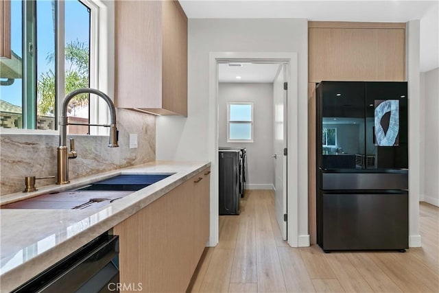 6832 Cantaloupe Ave, Van Nuys, CA 91405 - kitchen with freestanding refrigerator, dishwashing machine, washer and clothes dryer, tasteful backsplash, and modern cabinets