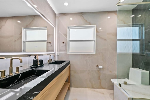 6832 Cantaloupe Ave, Van Nuys, CA 91405 - bathroom with double vanity, a shower with door, and tile walls