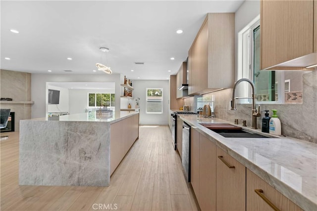 6832 Cantaloupe Ave, Van Nuys, CA 91405 - kitchen featuring a large island, light stone counters, modern cabinets, light wood-style floors, and light brown cabinetry