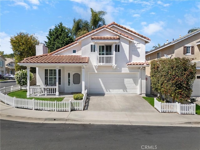 2 Chestnut Dr, Aliso Viejo, CA 92656 - mediterranean / spanish house featuring a tile roof, covered porch, a garage, and a fenced front yard