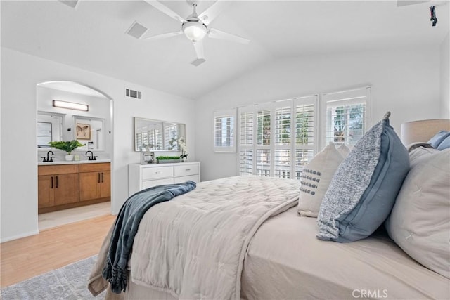 2 Chestnut Dr, Aliso Viejo, CA 92656 - bedroom with vaulted ceiling, light wood-style flooring, arched walkways, ensuite bath, and a ceiling fan