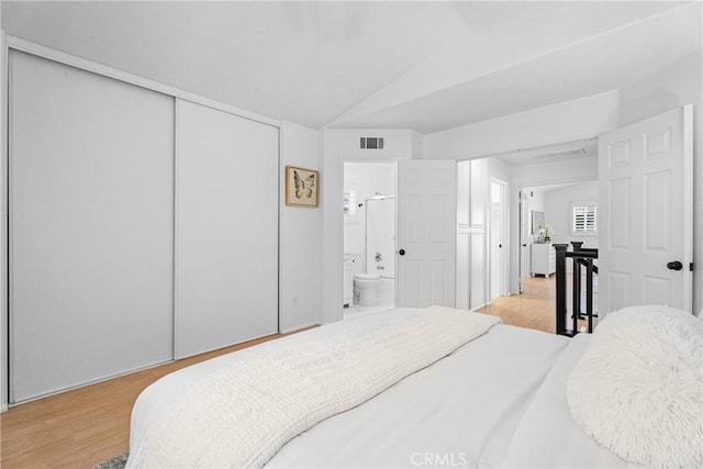 2 Chestnut Dr, Aliso Viejo, CA 92656 - bedroom with wood finished floors, ensuite bathroom, and vaulted ceiling