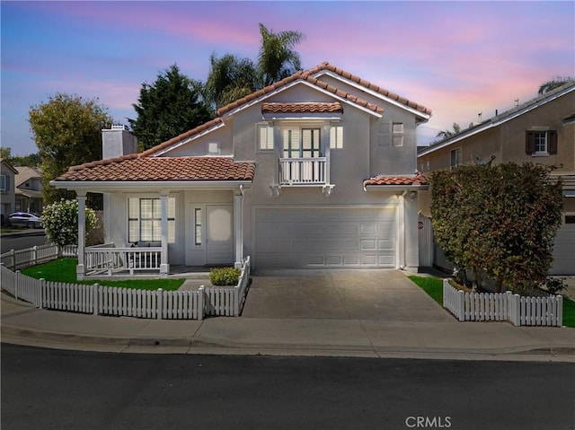 2 Chestnut Dr, Aliso Viejo, CA 92656 - mediterranean / spanish home with a tiled roof, covered porch, a fenced front yard, a chimney, and concrete driveway