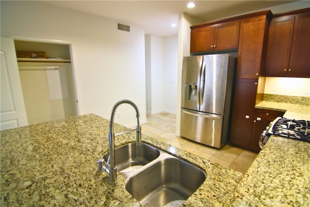 629 Traction Ave Unit 508, Los Angeles, CA 90013 - kitchen with stainless steel fridge with ice dispenser, light stone counters, recessed lighting, range with gas cooktop, and light tile patterned floors