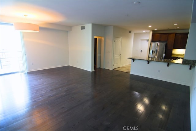 629 Traction Ave Unit 508, Los Angeles, CA 90013 - unfurnished living room featuring dark wood-style flooring and recessed lighting