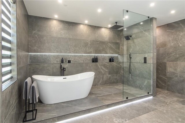 18824 Juniper Springs Dr, Canyon Country, CA 91321 - full bathroom featuring tile walls, marble tiled floors, a freestanding tub, walk in shower, and recessed lighting