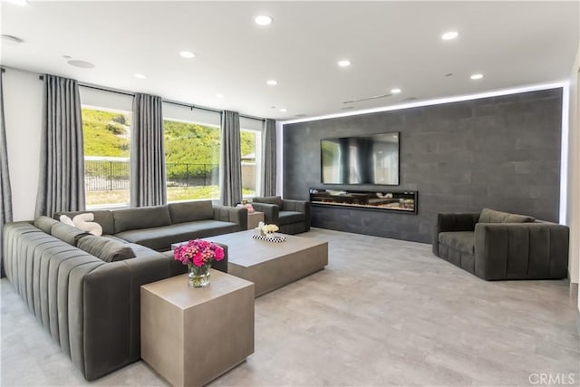 18824 Juniper Springs Dr, Canyon Country, CA 91321 - living room featuring recessed lighting, a glass covered fireplace, and finished concrete flooring