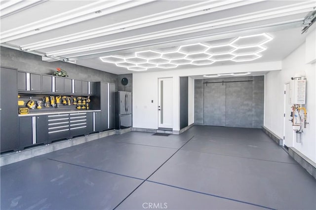 18824 Juniper Springs Dr, Canyon Country, CA 91321 - garage featuring freestanding refrigerator and baseboards