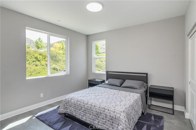 18824 Juniper Springs Dr, Canyon Country, CA 91321 - bedroom featuring baseboards and concrete flooring