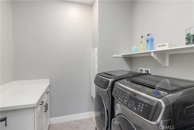 18824 Juniper Springs Dr, Canyon Country, CA 91321 - washroom featuring washer and clothes dryer, cabinet space, and light tile patterned flooring