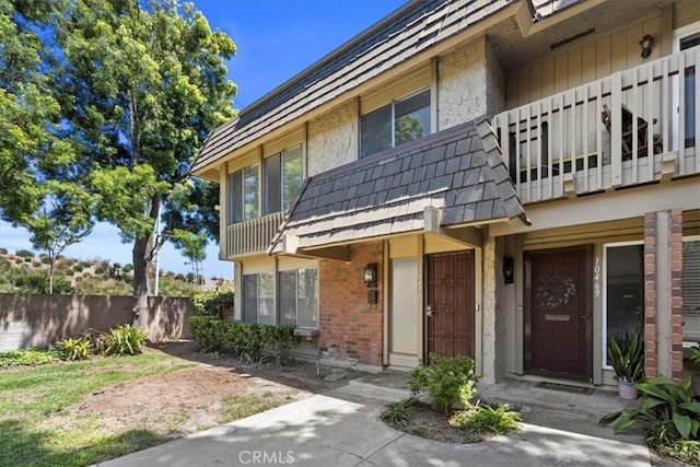 10473 Smoke River Ct, Fountain Valley, CA 92708 - view of front of property with brick siding and a balcony