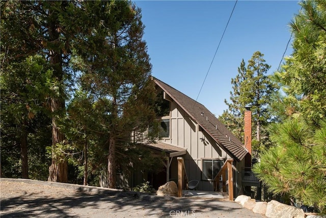 832 Rhine Rd, Lake Arrowhead, CA 92352 - view of side of property featuring a chimney and board and batten siding