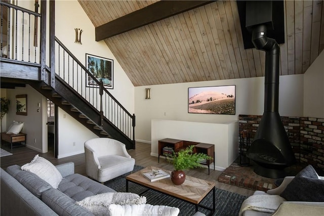 832 Rhine Rd, Lake Arrowhead, CA 92352 - living area featuring a wood stove, wood finished floors, stairs, a wooden ceiling with exposed beams, and high vaulted ceiling