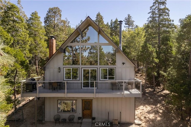 832 Rhine Rd, Lake Arrowhead, CA 92352 - back of house with a chimney and a patio