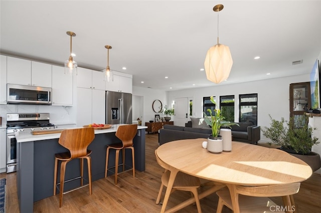 2329 Vineyard Ave, Los Angeles, CA 90016 - dining area featuring wood finished floors and recessed lighting