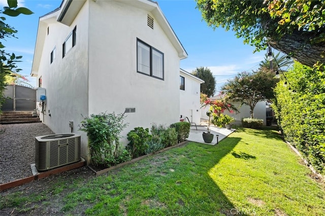 2329 Vineyard Ave, Los Angeles, CA 90016 - view of side of property with stucco siding, a yard, and a patio area