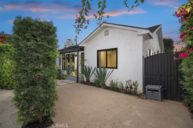 2329 Vineyard Ave, Los Angeles, CA 90016 - view of front of property with stucco siding, a gate, and a patio