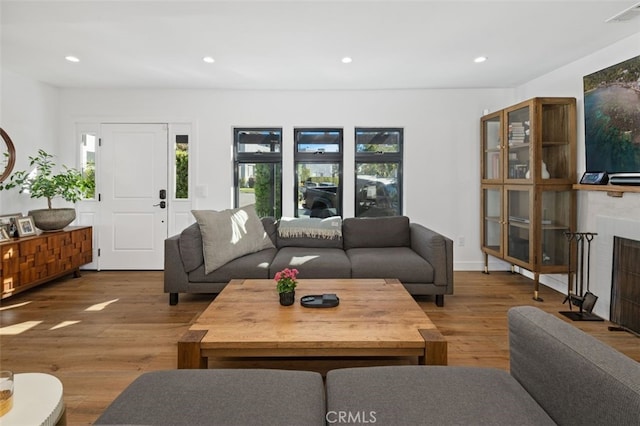 2329 Vineyard Ave, Los Angeles, CA 90016 - living area with wood finished floors, recessed lighting, and a fireplace with flush hearth