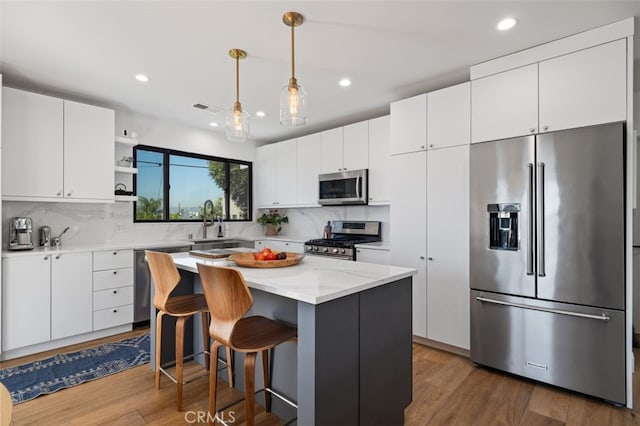 2329 Vineyard Ave, Los Angeles, CA 90016 - kitchen featuring appliances with stainless steel finishes, open shelves, decorative backsplash, white cabinets, and recessed lighting