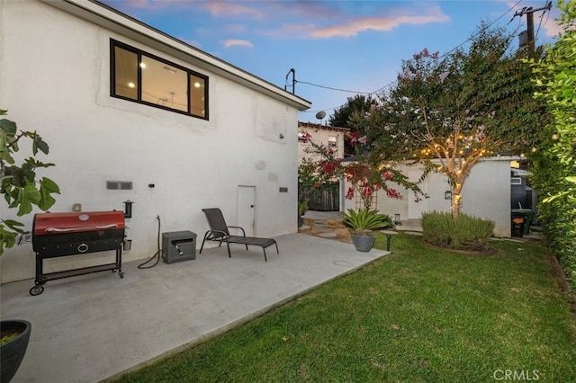 2329 Vineyard Ave, Los Angeles, CA 90016 - back of house featuring a lawn, a patio area, and stucco siding