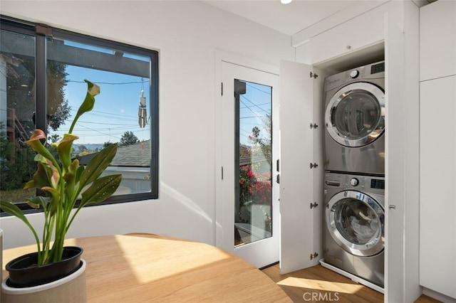 2329 Vineyard Ave, Los Angeles, CA 90016 - laundry area with stacked washer / dryer, wood finished floors, and plenty of natural light