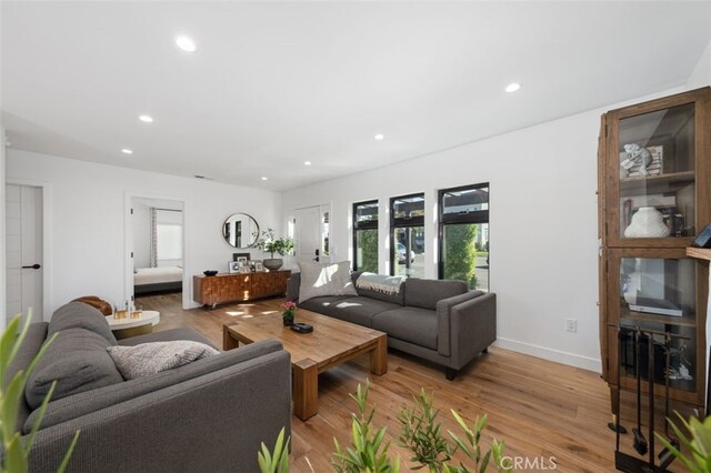 2329 Vineyard Ave, Los Angeles, CA 90016 - living room with light wood-style floors and recessed lighting