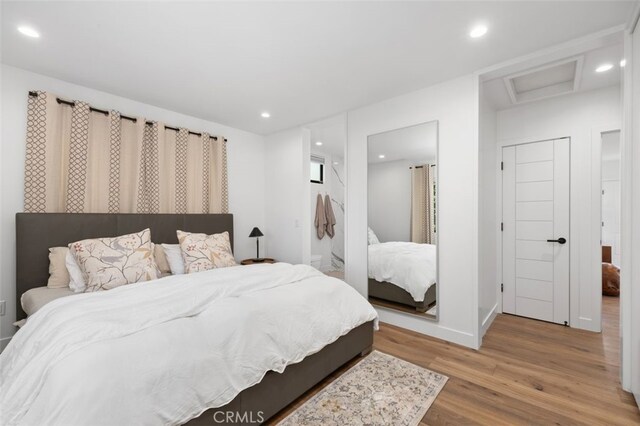 2329 Vineyard Ave, Los Angeles, CA 90016 - bedroom featuring wood finished floors, attic access, and recessed lighting