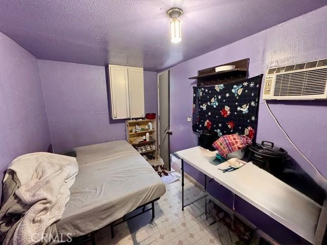 233 W 65th St, Los Angeles, CA 90003 - bedroom featuring light flooring and a textured ceiling