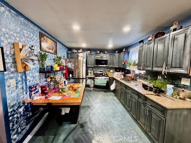 233 W 65th St, Los Angeles, CA 90003 - kitchen with appliances with stainless steel finishes, decorative backsplash, and recessed lighting