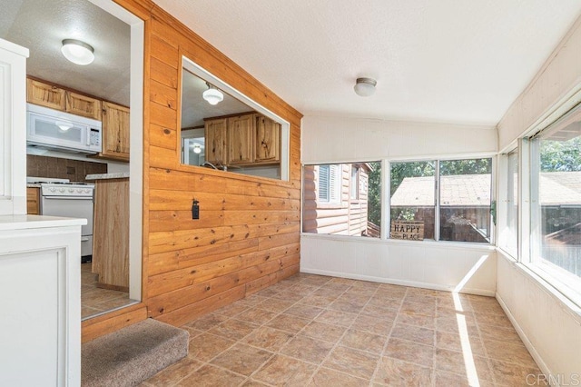 1211 Bridal Path, Rimforest, CA 92378 - unfurnished sunroom featuring stone finish flooring, wood walls, and a textured ceiling