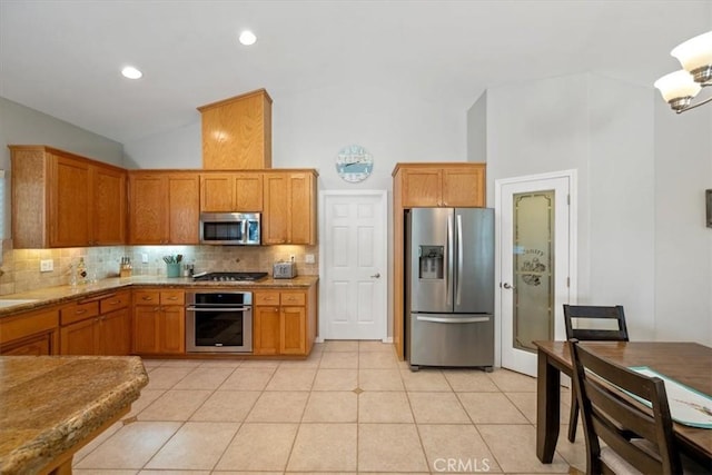 109 W Chestnut St, Nipomo, CA 93444 - kitchen with appliances with stainless steel finishes, tasteful backsplash, brown cabinetry, light tile patterned flooring, and high vaulted ceiling