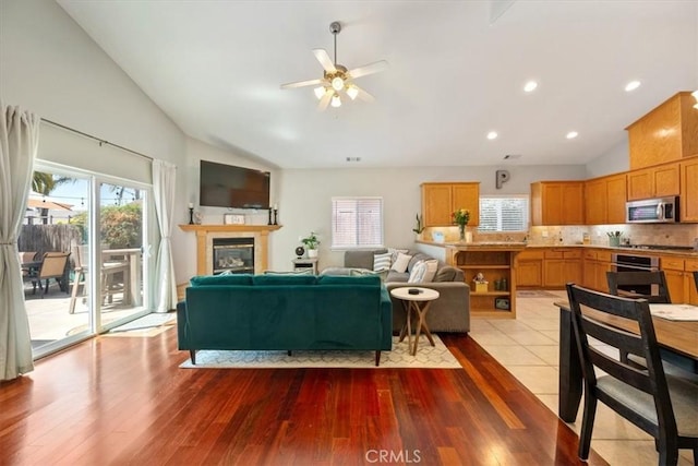 109 W Chestnut St, Nipomo, CA 93444 - living room featuring ceiling fan, wood finished floors, a glass covered fireplace, and high vaulted ceiling