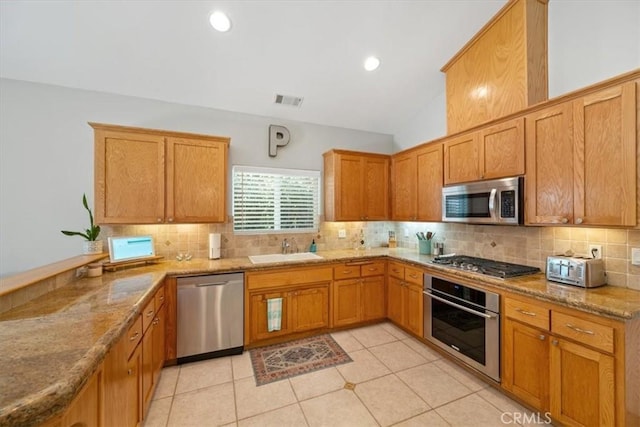 109 W Chestnut St, Nipomo, CA 93444 - kitchen featuring appliances with stainless steel finishes, tasteful backsplash, light stone counters, light tile patterned floors, and lofted ceiling