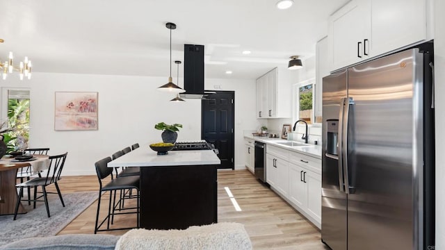 8865 Highsmith Ln, San Diego, CA 92119 - kitchen with stainless steel appliances, a center island, extractor fan, light countertops, and white cabinetry