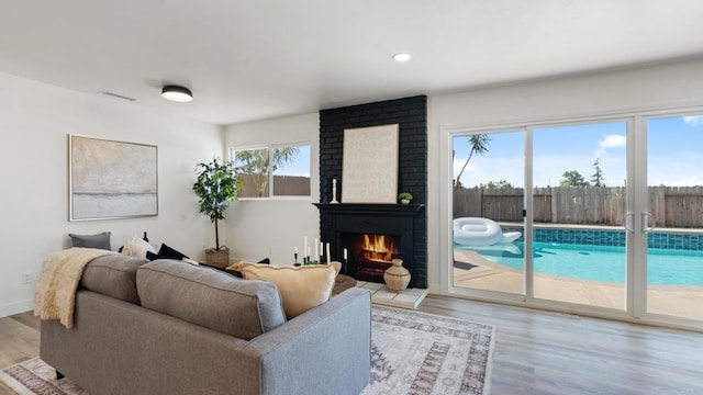 8865 Highsmith Ln, San Diego, CA 92119 - living area with wood finished floors, a fireplace, and recessed lighting