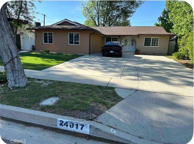 24017 Sylvan St, Woodland Hills, CA 91367 - single story home with driveway, stucco siding, and a front yard