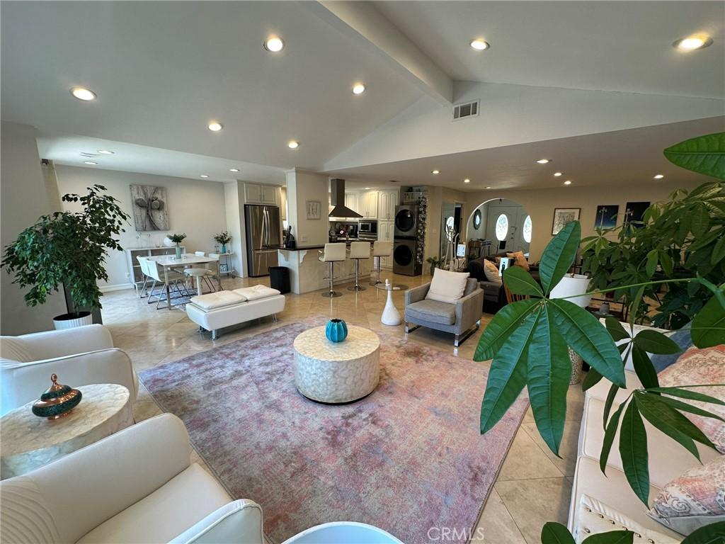 24017 Sylvan St, Woodland Hills, CA 91367 - living area featuring stacked washer and clothes dryer, recessed lighting, and light tile patterned floors