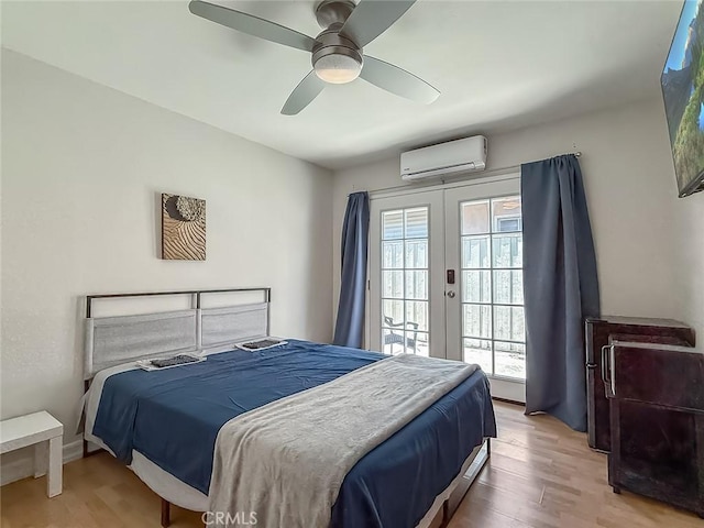 24017 Sylvan St, Woodland Hills, CA 91367 - bedroom featuring a wall mounted air conditioner, french doors, access to exterior, and light wood-type flooring