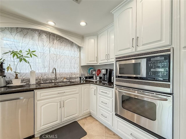 24017 Sylvan St, Woodland Hills, CA 91367 - kitchen with appliances with stainless steel finishes, light tile patterned floors, white cabinets, dark stone counters, and recessed lighting