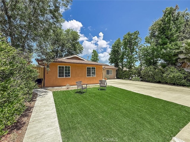 24017 Sylvan St, Woodland Hills, CA 91367 - view of front of house featuring stucco siding and a front lawn