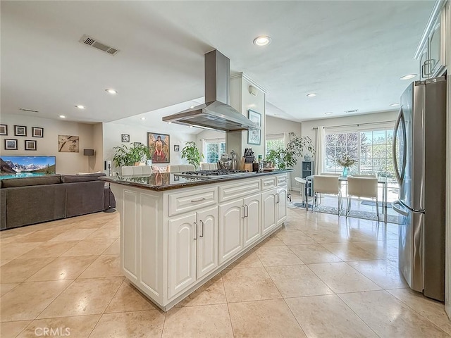 24017 Sylvan St, Woodland Hills, CA 91367 - kitchen featuring wall chimney range hood, appliances with stainless steel finishes, open floor plan, light tile patterned floors, and recessed lighting