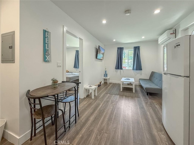 24017 Sylvan St, Woodland Hills, CA 91367 - sitting room featuring an AC wall unit, electric panel, wood finished floors, and recessed lighting